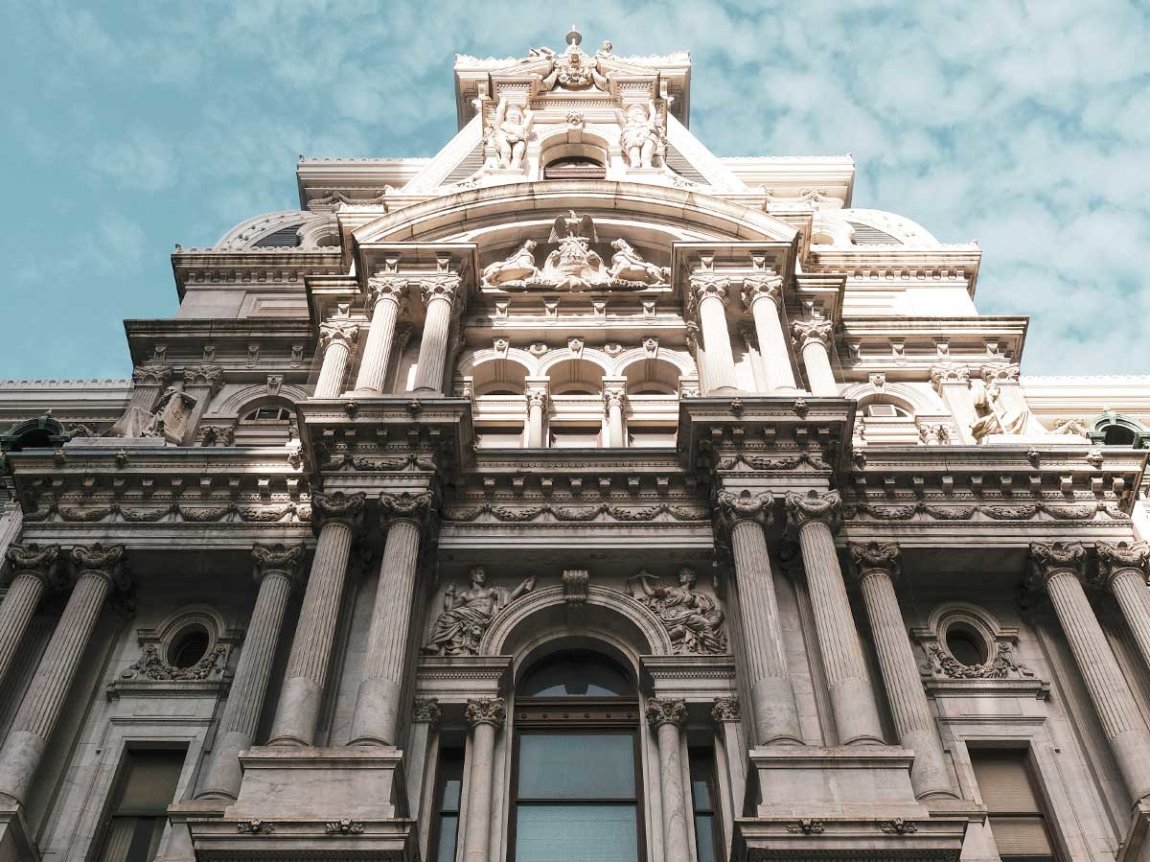 the facade of Philadelphia City Hall against an aqua sky