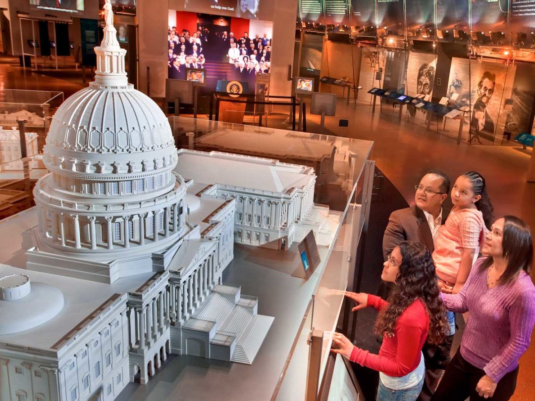 visitors to the center gaze at a scaled replica of the U.S. Capitol