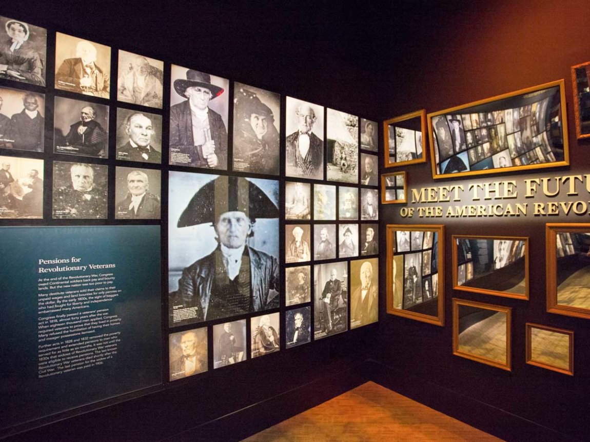 a gallery containing walls of images of people in Revolution-era attire