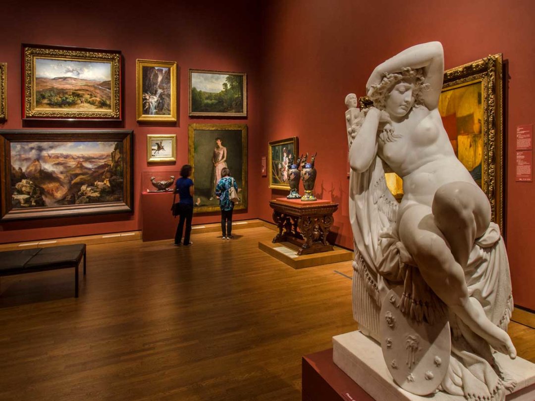 a museum painting gallery, with a statueo in the foreground