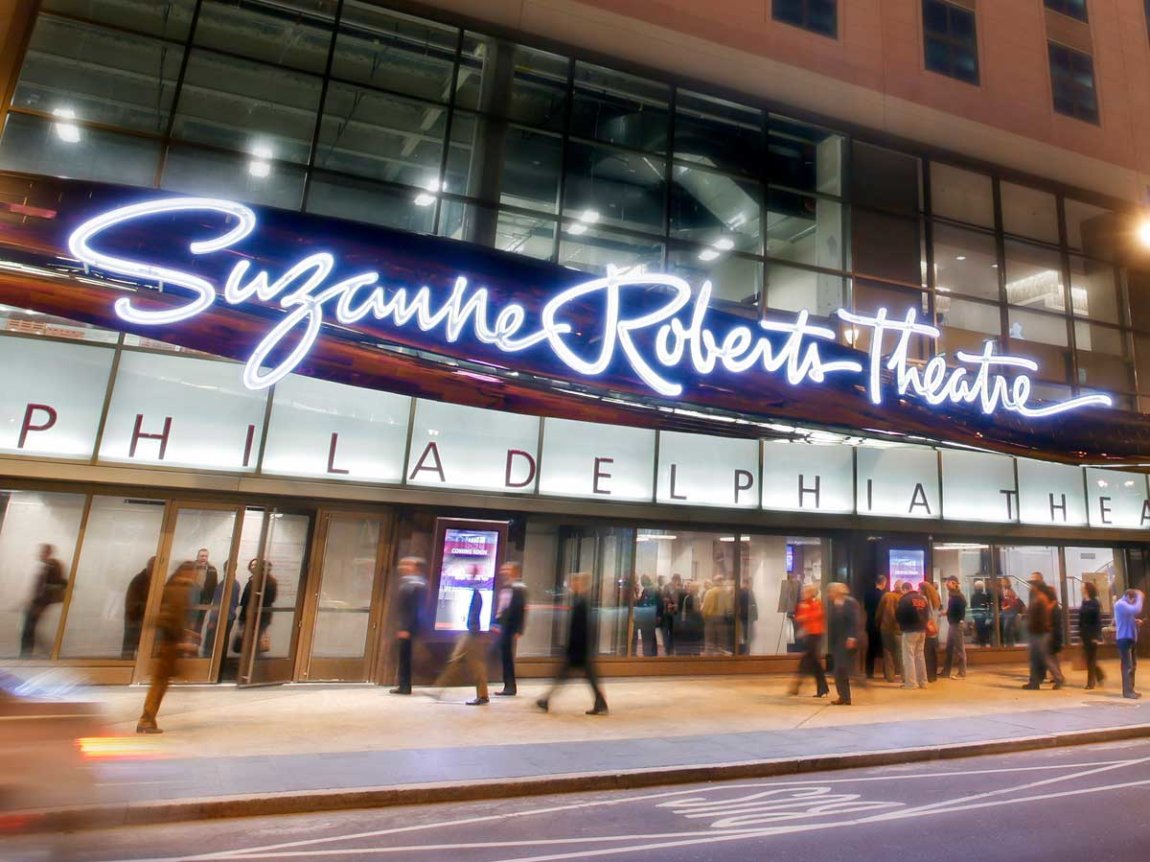 the front of the Suzanne Roberts Theater, with its sign lighted up